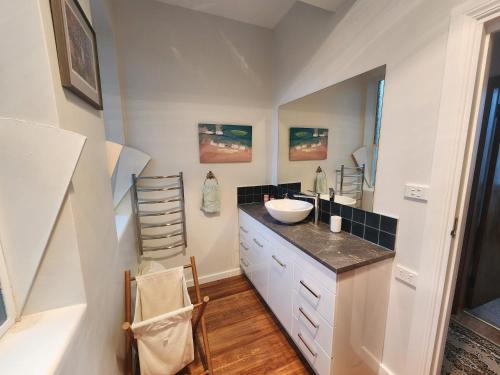 a bathroom with a sink and a counter top at The Church House- Boutique Comfort in Balclutha
