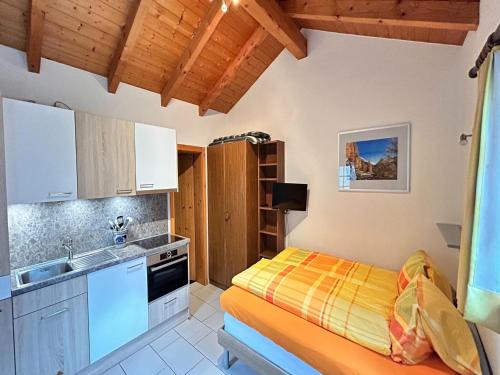 a small kitchen with a bed and a sink at Chalet Stadel Alpine Comfort in Saas-Grund