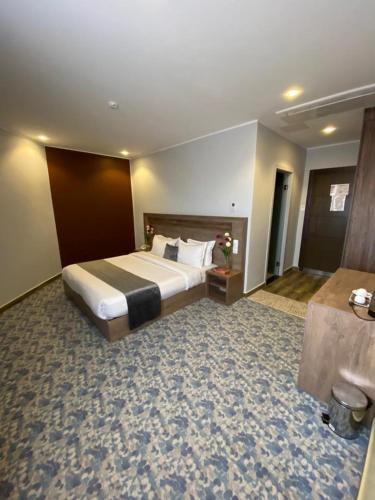 a bedroom with a large bed in a hotel room at Blue sky hotel in Oran