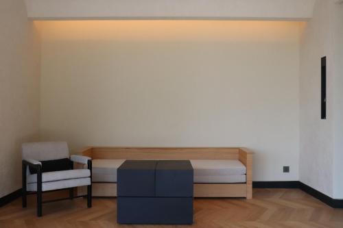 a room with a bed and a chair in it at Ije Busan in Busan