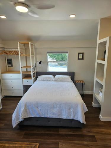 a bedroom with a large bed and a window at Villa del Sol St Pete The Loft in St. Petersburg