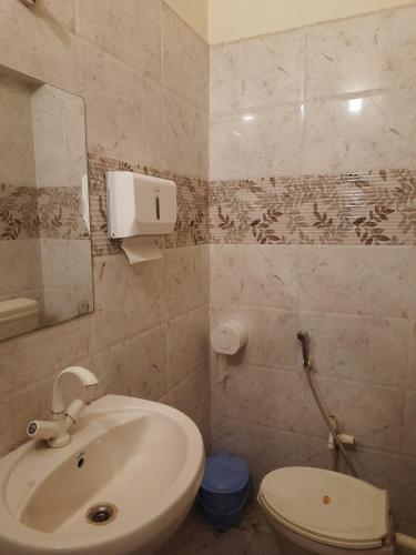 a bathroom with a sink and a toilet at Colonial Heritage Bungalow in Prayagraj