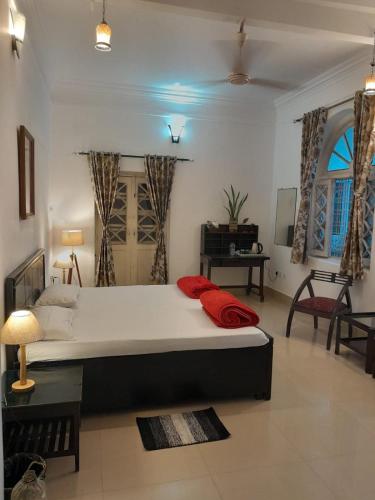 a bedroom with a large bed in a room at Colonial Heritage Bungalow in Prayagraj