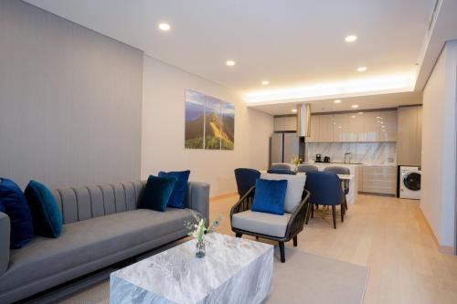 a living room with a couch and chairs and a table at Wyndham Bangkok Queen Convention Centre in Bangkok