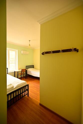 a room with two beds and a yellow wall at Areni Wine Art in Areni
