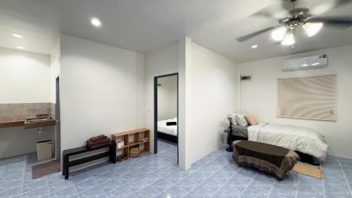 a bedroom with a bed and a mirror at Neo Haus Fishermans Village Bophut in Ko Samui
