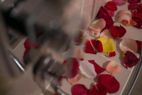 a bunch of red and white flowers on a mirror at V8 Hotel Johor Bahru in Johor Bahru