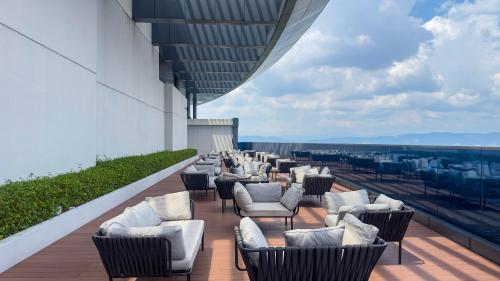 a row of chairs on the roof of a building at MOONWAY SUITES At EATON KLCC in Kuala Lumpur