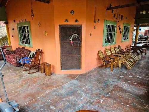 a room with a group of chairs and a door at Casa de Campo La Trigue in Comayagua