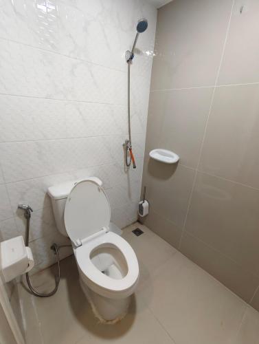 a small bathroom with a toilet and a shower at AuraHome282 in Khlong Luang
