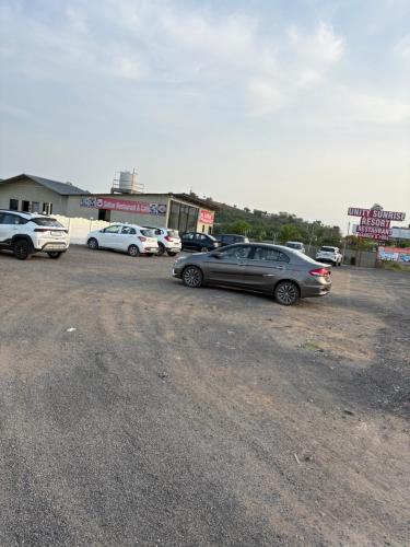 a group of cars parked in a parking lot at Unity Sunrise Resort Best Hotel Near Statue of Unity in Kevadia