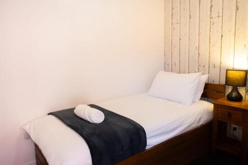 a small bed with two pillows on top of it at Haka House Taupo in Taupo