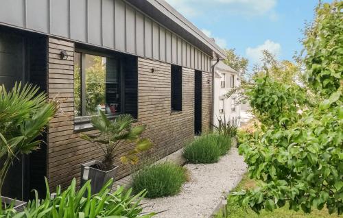 a house with a garden next to a building at 3 Bedroom Lovely Home In Fouesnant in Fouesnant