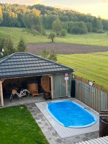 a large swimming pool next to a gazebo at Sielski Zaułek Guciów u Dorotki -Basen,Jacuzzi,Sauna in Guciów