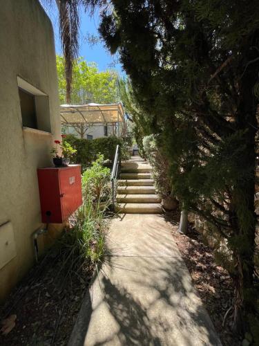 a stairway leading up to a house with trees at Kalimera Garden in Ma‘yan Barukh