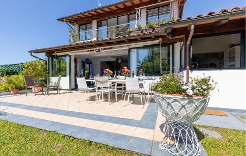 a house with a patio with a table and chairs at Colmate Pietrasanta - Versilia in Pietrasanta