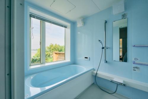 a bathroom with a sink and a window at 1NLDK hyuga in Hyuga
