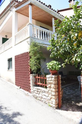 a house with a balcony on the side of it at Kiveri Traditional Villa in Kiveri