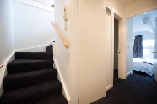 a staircase in a room with a bedroom and a bed at The Art Stable in Wellington