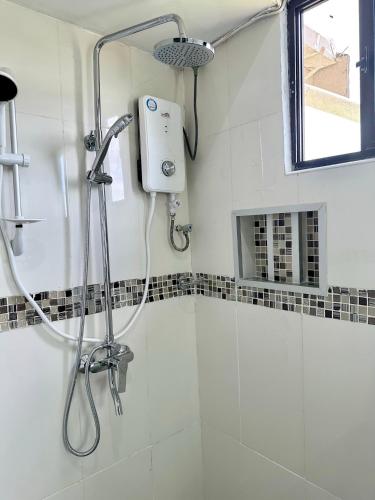 a shower in a bathroom with a shower head at Furnished Modern Unit Great Location Labasa Jumanzuls Abode in Labasa
