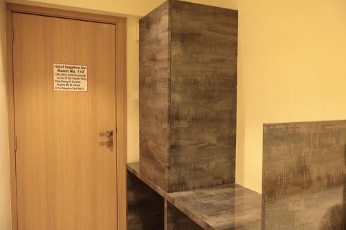 a room with a door with a sign on the wall at Hotel Sapphire Inn Residency in Thane