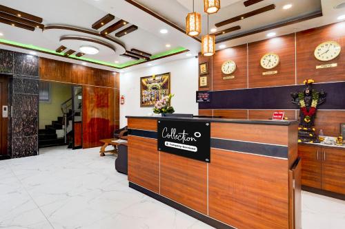 a lobby of a restaurant with clocks on the wall at Super Collection O Tirumala Road Near Alipiri in Tirupati