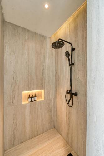 a shower in the corner of a bathroom at Cemagi Suites Brand New 3BR Villas in Cemagi