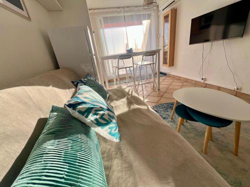 a living room with a couch and a table at Sea Chic - Naturist in Cap d'Agde