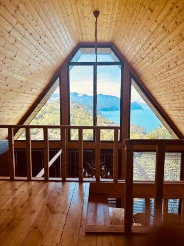 a large room with a large window in a cabin at Cottage KOLKHA in Sarpi