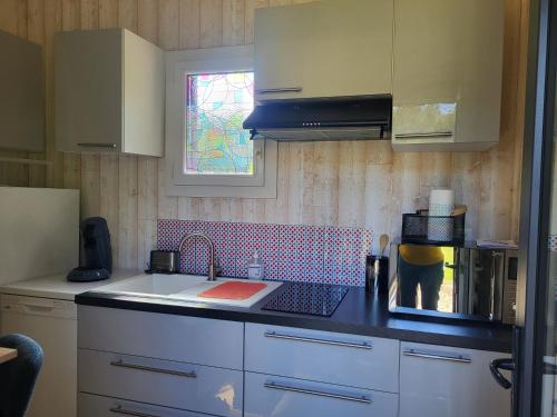 a kitchen with a sink and a counter top at Gite le Meillonais in Le Nizan