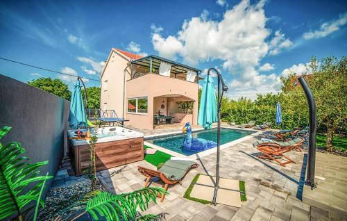 a home with a swimming pool and a house at 4 Bedroom Nice Home In Polaca in Polača