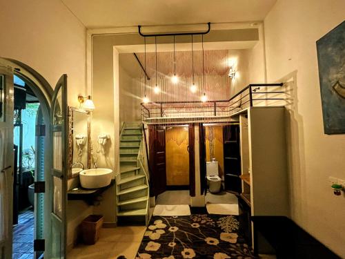 a bathroom with a sink and a toilet and a mirror at LE JARDIN DU FORT - GALLE in Galle
