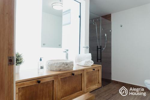a bathroom with a sink and a shower at 201 Arje Suites Campestre by Alegría Housing in Las Pilas