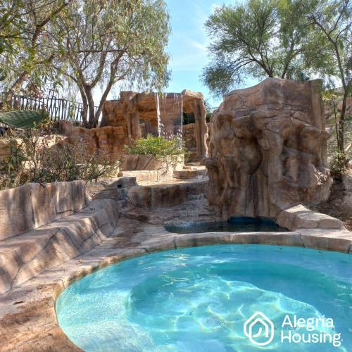 a pool with a water slide in a backyard at 202 Arje Suites Campestre by Alegría Housing in Las Pilas