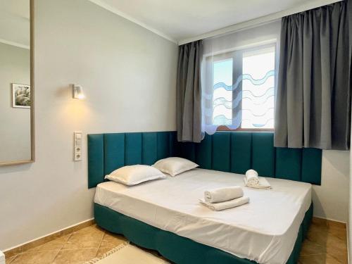 a bedroom with a bed with two towels on it at Arkite - Private apartment - BSR in Sunny Beach