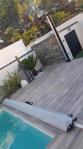 une piscine à côté d'une maison avec une porte dans l'établissement Villa avec Piscine pour un séjour d'exception !, à Calvisson