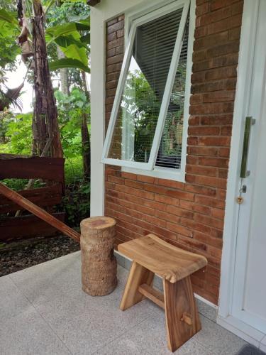 a wooden bench sitting next to a window at Guest House T in Bedoyo