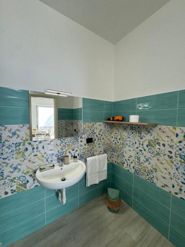 a bathroom with a sink and blue and white tiles at Villa Chiena Forio in Ischia
