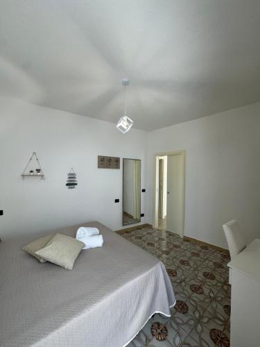 a white room with a bed and a window at Villa Chiena Forio in Ischia