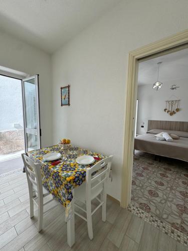a dining room with a table and chairs and a bed at Villa Chiena Forio in Ischia