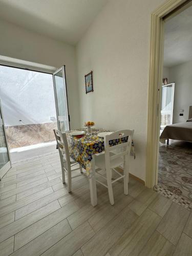 a dining room with a table and chairs and a window at Villa Chiena Forio in Ischia
