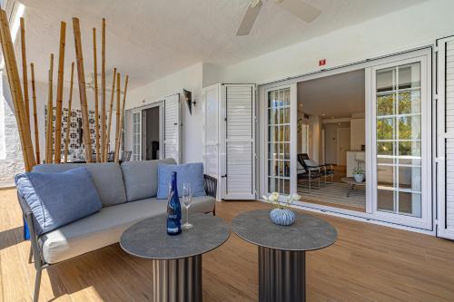 a living room with a couch and two tables at Luxurious apartment in Puente Romano, Marbella (Golden Mile) in Marbella