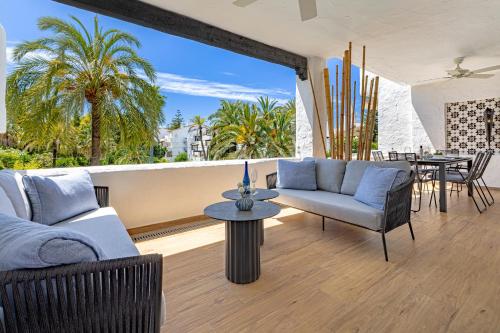 a living room with a couch and a table at Luxurious apartment in Puente Romano, Marbella (Golden Mile) in Marbella