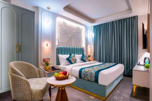 a hotel room with a bed and a chair at Hotel Horizon By Shanti in New Delhi