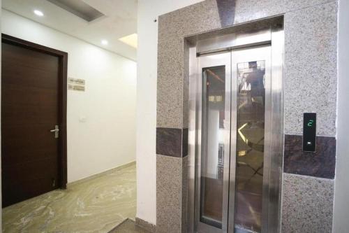 a elevator in a building with water on the floor at Hotel Diamond Stay 10 Mints Walking From Nizamuddin Railway Station in New Delhi