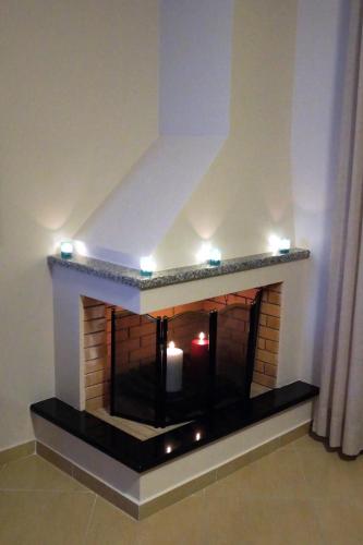 a brick fireplace with lights on top of it at Cavos Fokidos in Chiliadou