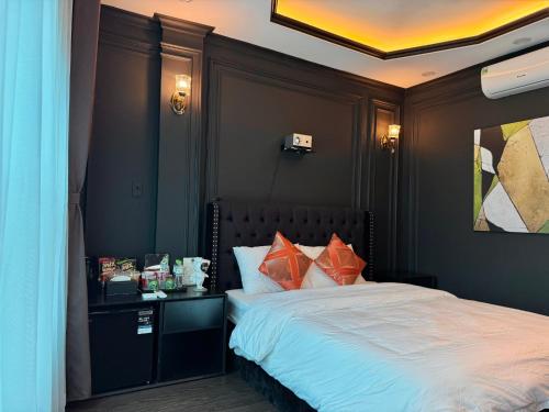 a bedroom with a large bed with aoc at Star Night Hotel and Apartment in Hanoi