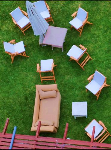a group of chairs and tables on the grass at شاليه للايجار مارينا العلمين in El Alamein