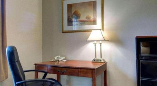 a desk with a telephone and a lamp on it at Comfort Inn Foxboro - Mansfield in Foxborough