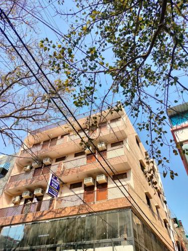 a tall building with balconies on the side of it at Hotel Diamond Stay 10 Mints Walking From Nizamuddin Railway Station in New Delhi